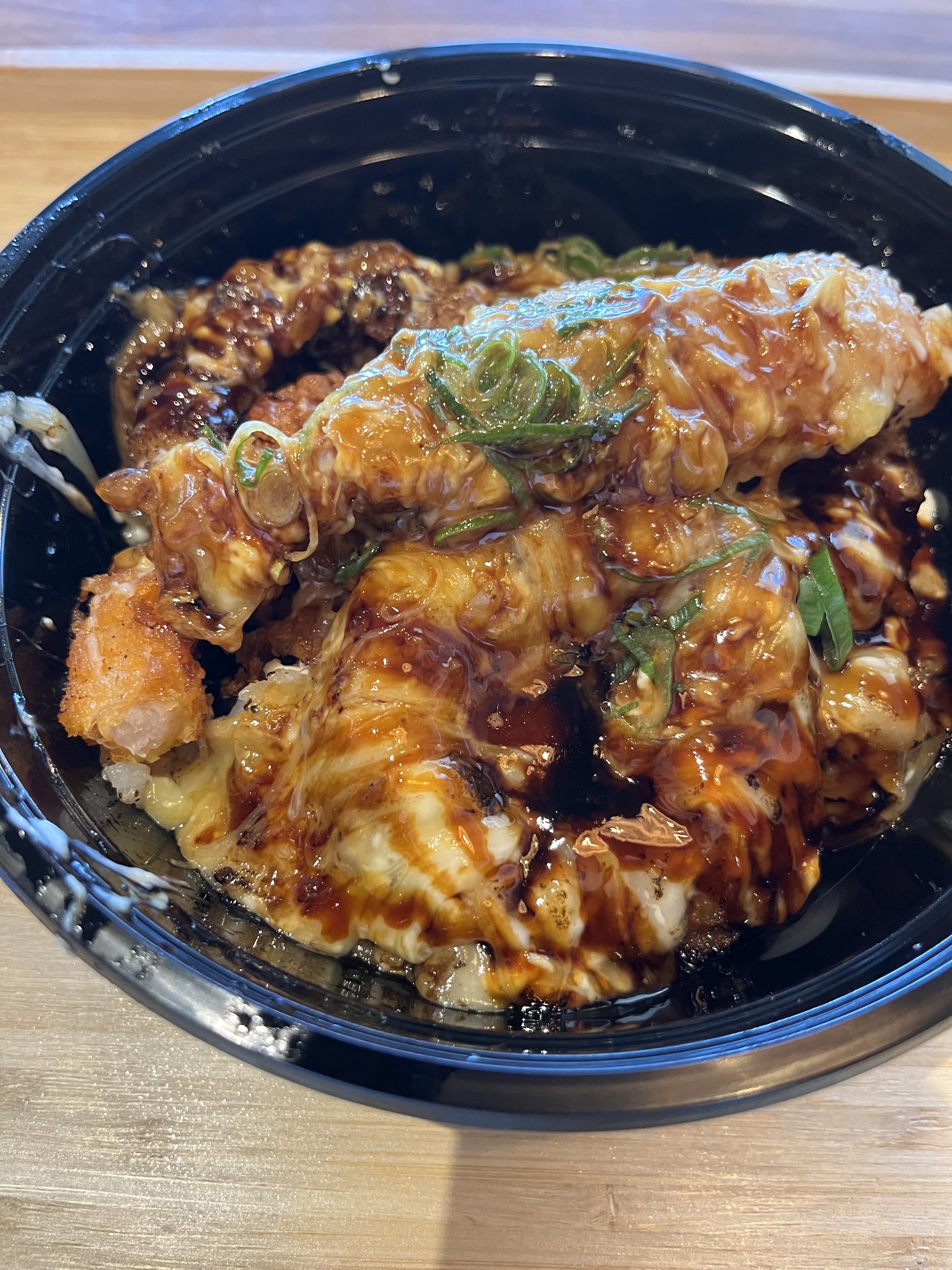 Karaage chicken bowl with sauce drizzled over rice