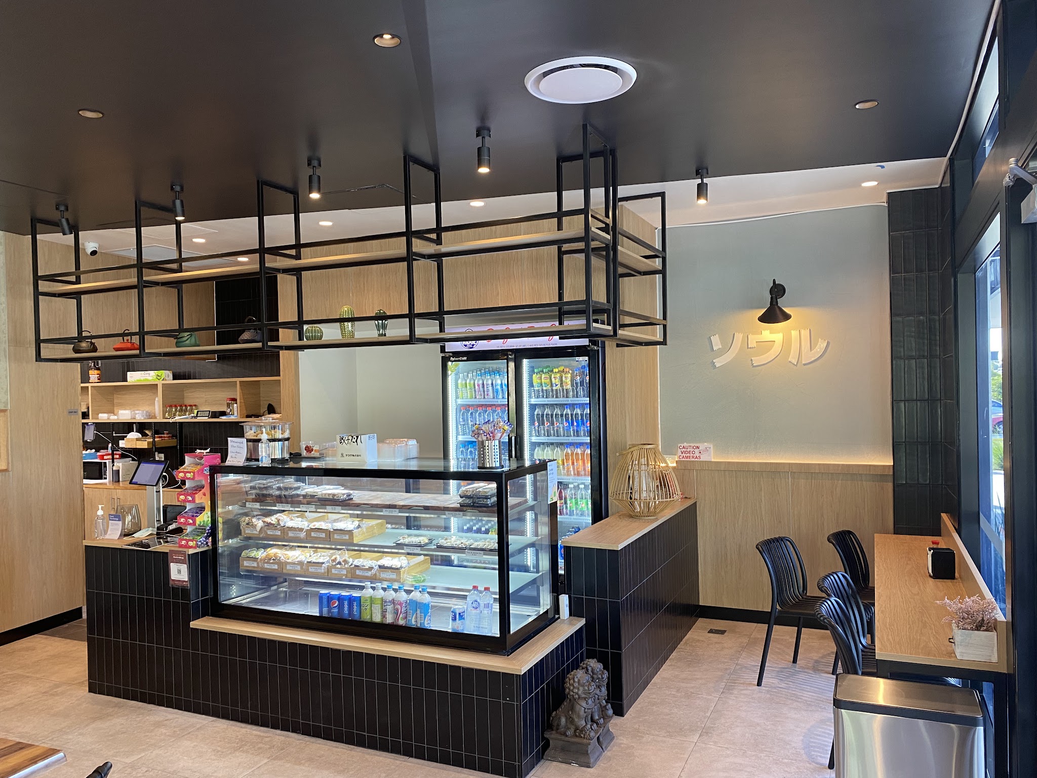 The Sushi Soul counter with a glass display of packed sushi trays, drinks fridge and ソウル wall lettering