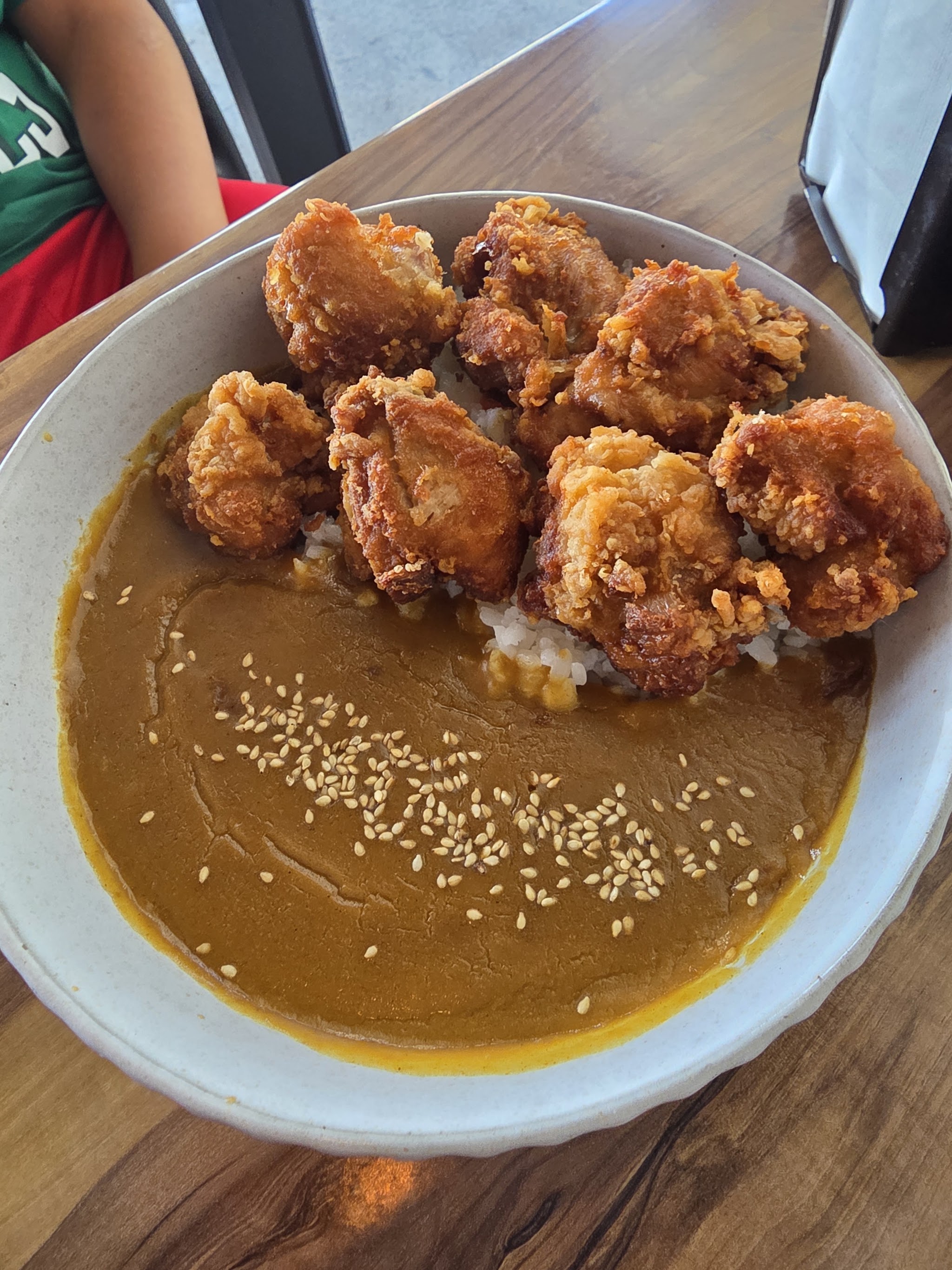 Chicken curry rice bowl with karaage and sesame seeds